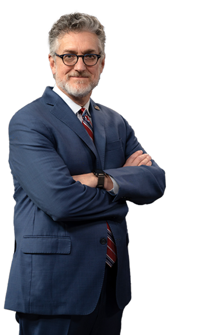 Kevin D. Freeman, standing with arms crossed in a blue suit